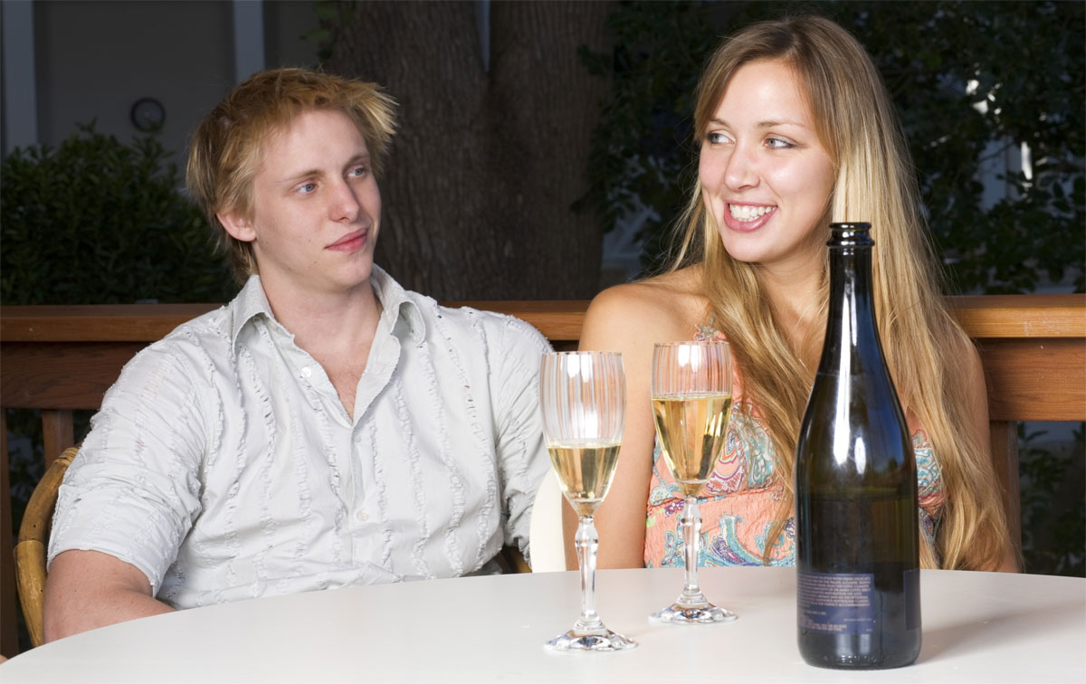 A man lacking confidence around a woman, even though she is sitting there having a drink with him.