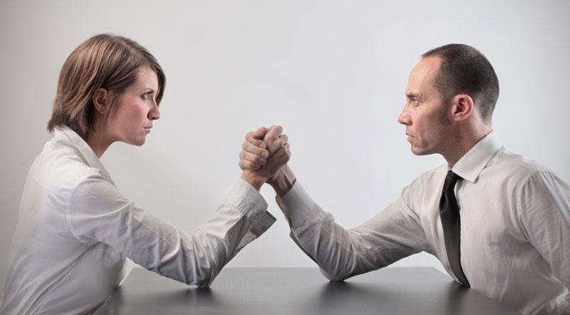 Woman and man about to arm wrestle